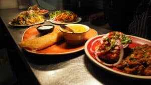 A beautifully set Indian dining table with various traditional dishes.